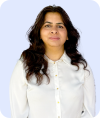 Woman with curly dark brown hair wearing white shirt looking forward on light blue background