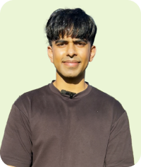 Man with black hair wearing brown shirt looking forward on light green background