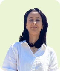 Woman with white shirt and black hair looking forward on light green background